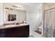 Bathroom featuring double sinks, a large mirror, and a shower with patterned curtain at 3528 Seneca Club Loop # 103 - C, Orlando, FL 32808