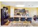 Kitchen features large island with seating, dark cabinetry, and open floor plan with ample lighting at 3528 Seneca Club Loop # 103 - C, Orlando, FL 32808