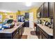 An open kitchen features granite countertops and views of the dining and living area at 3528 Seneca Club Loop # 103 - C, Orlando, FL 32808