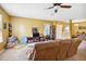 Inviting living room with carpeted floor, ceiling fan, and convenient access to entryway at 3528 Seneca Club Loop # 103 - C, Orlando, FL 32808