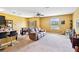 Open-concept living room with carpeted floor, ceiling fan, and casual dining area at 3528 Seneca Club Loop # 103 - C, Orlando, FL 32808