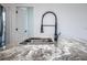 Close up of an undermount kitchen sink, granite countertops, and industrial sprayer faucet at 411 St Johns Ln, Kissimmee, FL 34759