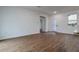 The living area features wood flooring, natural light, and white walls at 411 St Johns Ln, Kissimmee, FL 34759