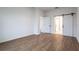 Bedroom featuring wood floors and a barn door to the bathroom at 411 St Johns Ln, Kissimmee, FL 34759
