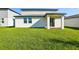 Backyard featuring well-maintained lawn, covered patio and contemporary exterior, great for outdoor living at 4514 Windy Oak Way, St Cloud, FL 34772