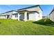Expansive backyard featuring lush green grass, an open patio, and a pristine exterior view at 4514 Windy Oak Way, St Cloud, FL 34772
