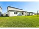 Spacious backyard with lush green grass, modern architecture, and ample space for outdoor activities at 4514 Windy Oak Way, St Cloud, FL 34772