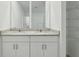 The spacious bathroom features double sinks, granite countertops, and bright lighting at 4514 Windy Oak Way, St Cloud, FL 34772