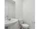 Powder room with a pedestal sink, neutral colors, and a modern design at 4514 Windy Oak Way, St Cloud, FL 34772