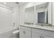 Bathroom with a double sink vanity, granite counters, and a shower-tub combo at 4514 Windy Oak Way, St Cloud, FL 34772