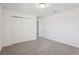 This carpeted bedroom features a double closet and doorway to another room at 4514 Windy Oak Way, St Cloud, FL 34772