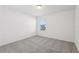 An open and sunny bedroom with plush gray carpet at 4514 Windy Oak Way, St Cloud, FL 34772