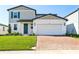 Well maintained two-story home featuring attached garage and brick paver driveway at 4514 Windy Oak Way, St Cloud, FL 34772