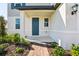 Covered front porch and entryway with brick paver walkway and professionally landscaped shrubs at 4514 Windy Oak Way, St Cloud, FL 34772
