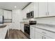 Bright kitchen showcasing stainless steel appliances, granite countertops, and white cabinetry at 4514 Windy Oak Way, St Cloud, FL 34772