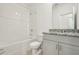 Well-lit bathroom featuring a shower over bath, granite countertop, and contemporary vanity at 4673 Cross Prairie Pkwy, St Cloud, FL 34772