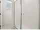 Modern bathroom featuring a glass-enclosed shower with tiled walls and natural light at 4673 Cross Prairie Pkwy, St Cloud, FL 34772