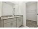 Bathroom with double granite vanity, undermount sinks, and large mirror at 4673 Cross Prairie Pkwy, St Cloud, FL 34772