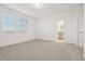 Bedroom view featuring two windows, neutral carpet, and ensuite access at 4673 Cross Prairie Pkwy, St Cloud, FL 34772