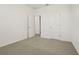 Bright bedroom with two doors, neutral carpet and white walls at 4673 Cross Prairie Pkwy, St Cloud, FL 34772