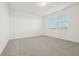 Bright bedroom featuring two windows, neutral carpet, and white walls at 4673 Cross Prairie Pkwy, St Cloud, FL 34772