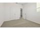Bright bedroom featuring neutral carpet, two doors, white walls, and baseboards at 4673 Cross Prairie Pkwy, St Cloud, FL 34772