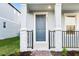 Inviting front entry with a gray door, brick walkway and stone columns at 4673 Cross Prairie Pkwy, St Cloud, FL 34772