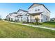Street view of modern gray homes with manicured lawns in a new development at 4673 Cross Prairie Pkwy, St Cloud, FL 34772