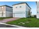 Two-story home features a brick driveway, lawn, and an attached two-car garage at 4673 Cross Prairie Pkwy, St Cloud, FL 34772