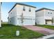 Two-story home features a brick driveway, lawn, and an attached two-car garage at 4673 Cross Prairie Pkwy, St Cloud, FL 34772