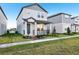 Charming two-story home with gray siding, landscaped yard and cozy front porch at 4673 Cross Prairie Pkwy, St Cloud, FL 34772
