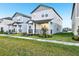 Row of modern gray homes with well-manicured lawns in a new community at 4673 Cross Prairie Pkwy, St Cloud, FL 34772