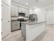 Well-lit kitchen featuring a granite island, stainless steel appliances, and white cabinets at 4673 Cross Prairie Pkwy, St Cloud, FL 34772