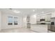 Open concept kitchen with gray cabinets and stainless steel appliances at 4673 Cross Prairie Pkwy, St Cloud, FL 34772
