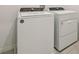 Modern laundry room featuring white, front loading washer and dryer machines at 4673 Cross Prairie Pkwy, St Cloud, FL 34772