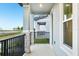 View from a cozy porch with stone columns and black iron railings at 4673 Cross Prairie Pkwy, St Cloud, FL 34772