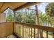 Balcony view overlooking a serene pond surrounded by lush trees and vegetation at 4828 Pebble Beach Dr # A, Orlando, FL 32811