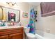 Bathroom with a wood vanity, marble countertop, a shower/tub and a toilet at 4828 Pebble Beach Dr # A, Orlando, FL 32811