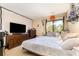 Bedroom featuring a large window, dresser with TV, and a comfortable bed at 4828 Pebble Beach Dr # A, Orlando, FL 32811