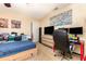 Bedroom with a desk setup, mounted tv and a comfortable bed at 4828 Pebble Beach Dr # A, Orlando, FL 32811