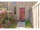 Close up of the entry door and surrounding landscaping features pink flowering bushes at 4828 Pebble Beach Dr # A, Orlando, FL 32811