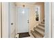 Entryway showcasing stairs with beige carpet, a white front door, and tile floor at 4828 Pebble Beach Dr # A, Orlando, FL 32811