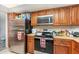Bright kitchen with stainless appliances and wooden cabinetry at 4828 Pebble Beach Dr # A, Orlando, FL 32811