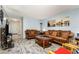 Comfortable living room with neutral colored sofas, decor, and wood look flooring at 4828 Pebble Beach Dr # A, Orlando, FL 32811
