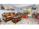 Open living room with lots of seating, light paint, and sliding glass door at 4828 Pebble Beach Dr # A, Orlando, FL 32811