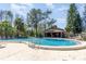 Community pool with clear blue water, surrounding greenery, and lounge chairs at 4828 Pebble Beach Dr # A, Orlando, FL 32811