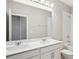 Modern bathroom featuring a double sink vanity with quartz countertop and tiled shower at 5093 Railroad Vine Aly, Winter Garden, FL 34787