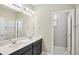 Modern bathroom with double sinks, sleek cabinets, and a large mirror at 5093 Railroad Vine Aly, Winter Garden, FL 34787