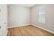 Simple bedroom with a window providing natural light and wood-look flooring at 5093 Railroad Vine Aly, Winter Garden, FL 34787