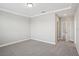 Bedroom with carpet floors, tray ceiling, and an open door at 5093 Railroad Vine Aly, Winter Garden, FL 34787